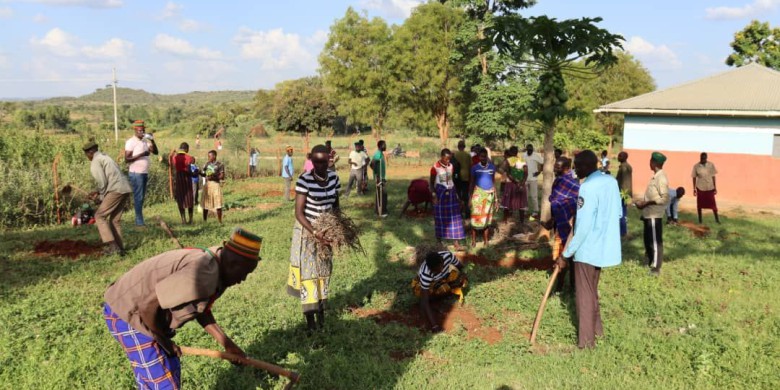 Community members plant drought-resistant indigenous trees.