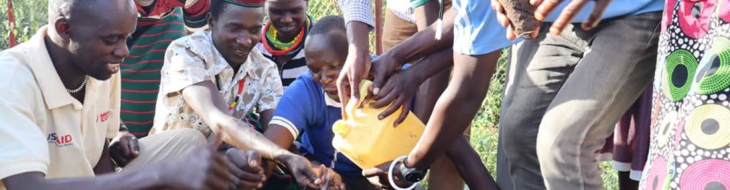 Community members in Uganda plant a tree