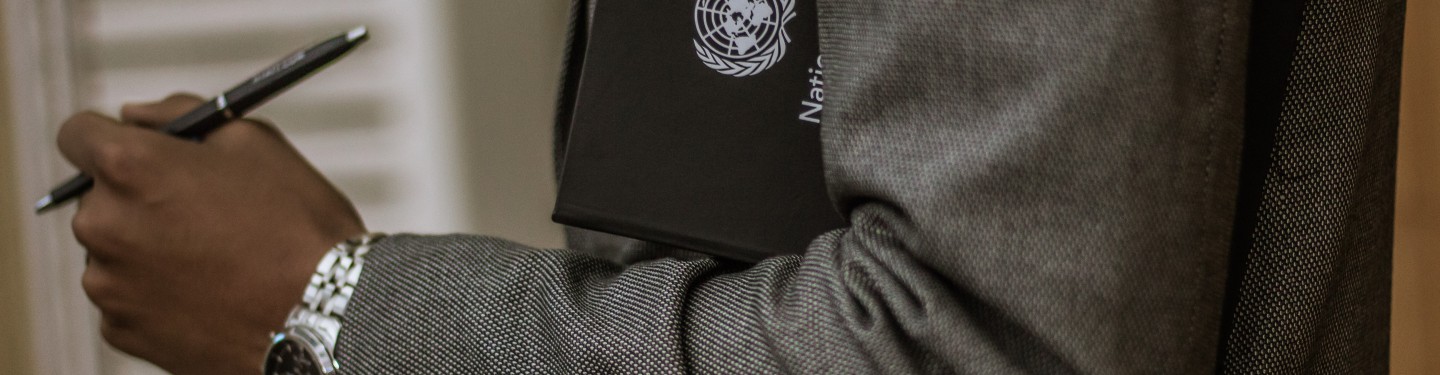 man holding UN folder