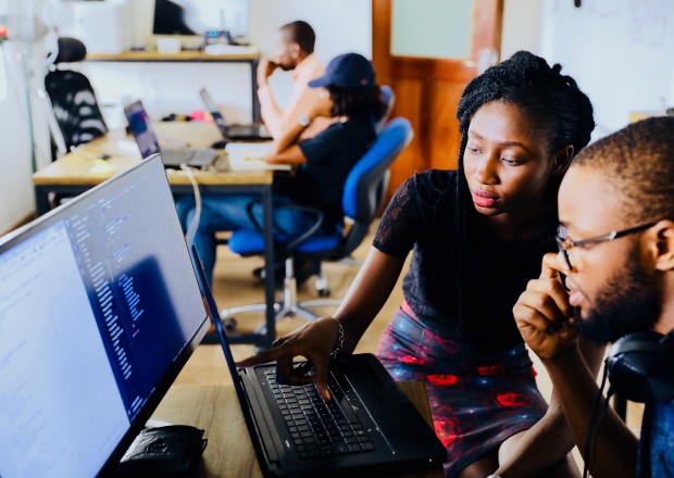 young people sitting in front of a computer