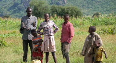 A group of people standing on a field in Africa