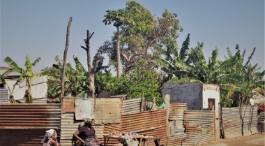 Two women sitting in front of their house in Mozambique