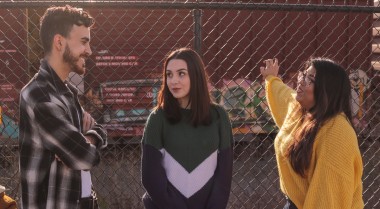 Photo of three young people standing together